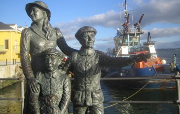 statue in front of boat